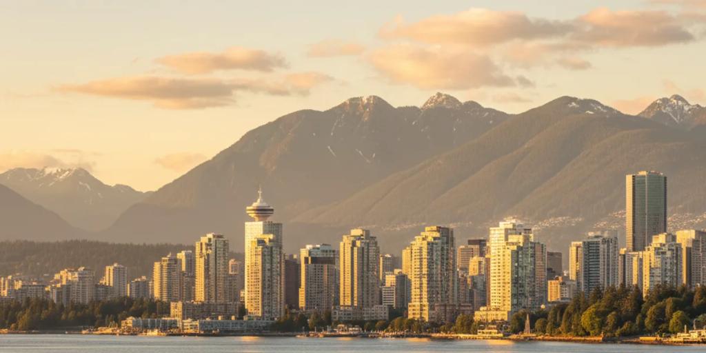 Szklana panorama Vancouver z hydroplanami kołującymi po Coal Harbour i górami North Shore w tle